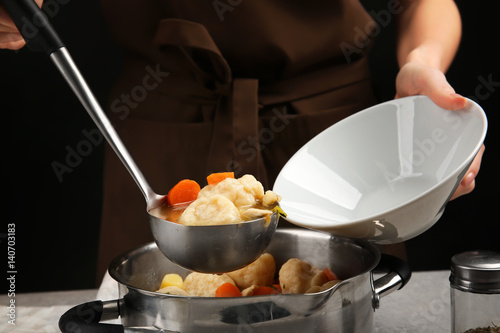 Fototapeta Naklejka Na Ścianę i Meble -  Pouring plate with delicious chicken and dumplings