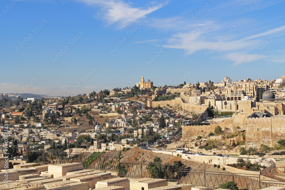 Dormition Abby, St. Peter in Gallicantu and al-Aqsa Mosque in a panoramic view of Jerusalem from a cemetery on the Mount of Olives beside the Kidron Valley.