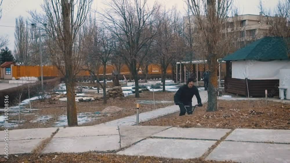 Teenager epic jumps on a hill in the park on BMX and does the trick on a winter day. Slow motion. 120 fps. Teenager epic jumps on a hill in the park on BMX and does the trick on a winter day. Slow motion. 120 fps.
