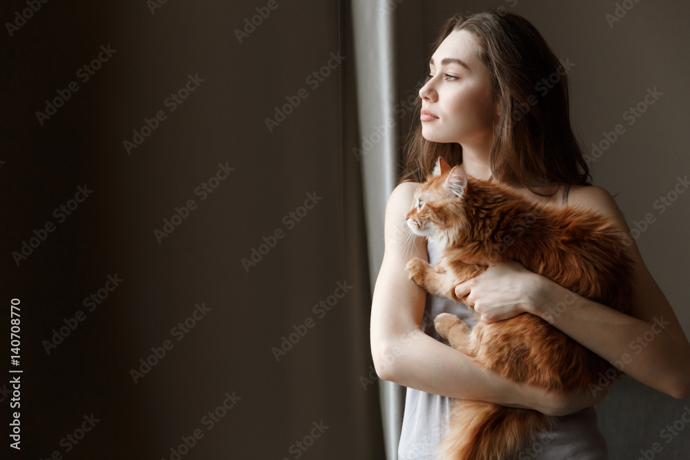 Young woman in nightie holding cat Young woman in nightie holding cat