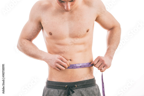 Male torso and blue tape measure on white background