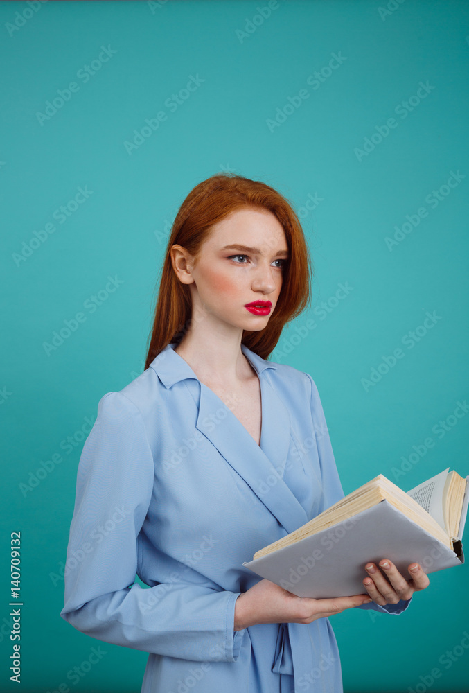 Vertical image of woman in bathrobe holding book