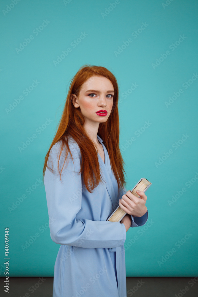 Vertical image of mystery woman in bathrobe holding book Vertical image of mystery woman in bathrobe holding book