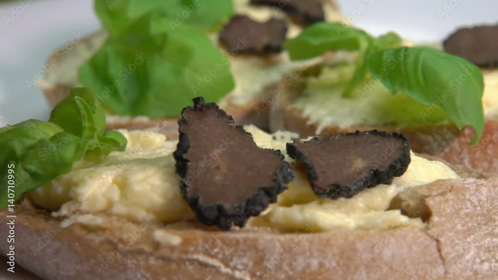 appetizer of ciabatta with cheese cream, basil and black truffle slices appetizer of ciabatta with cheese cream, basil and black truffle slices