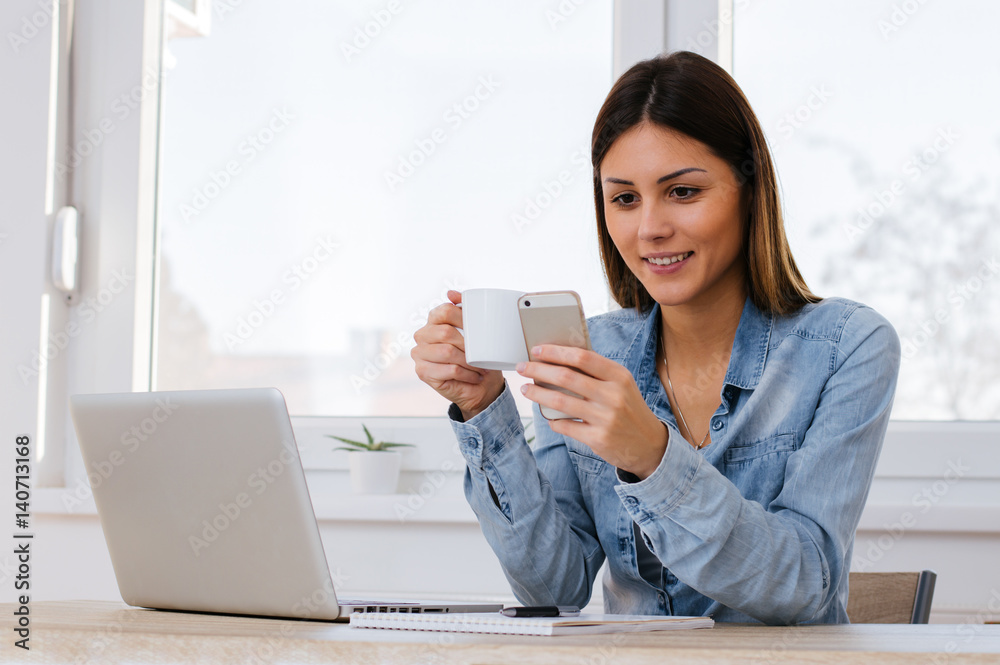 Charming woman with beautiful smile reading good news on mobile phone Charming woman with beautiful smile reading good news on mobile phone
