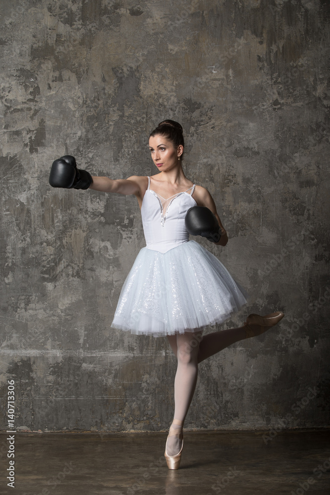 Slim ballerina in black boxing gloves Stock Photo | Adobe Stock