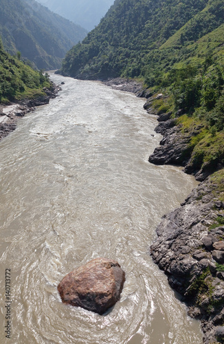 View from the bridge on a stormy nepal river photo