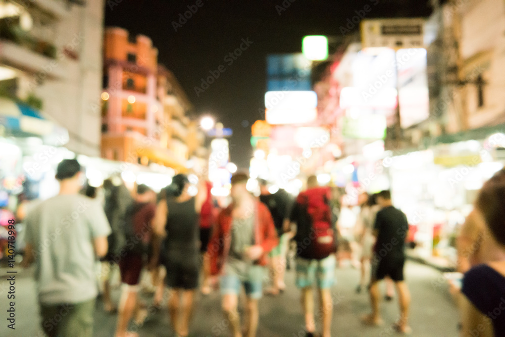 Blurred image of busy night life in the city. Defocused photo of night lights of the famous Ko San Road in Bangkok, Thailand.