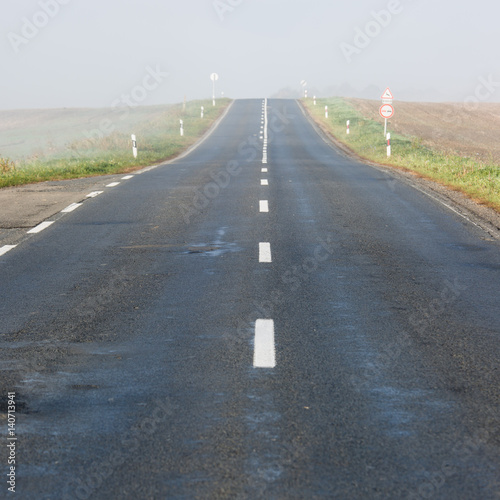 Empty long highway with fog