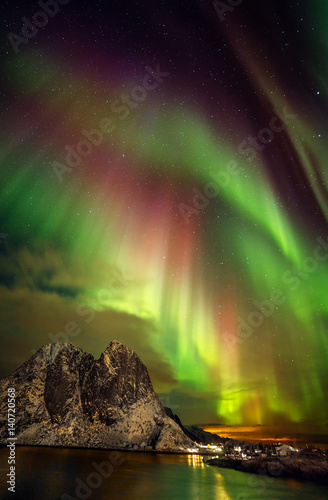 Aurora borealis (Polar lights) over the mountains in the North of Europe - Reine, Lofoten islands, Norway photo