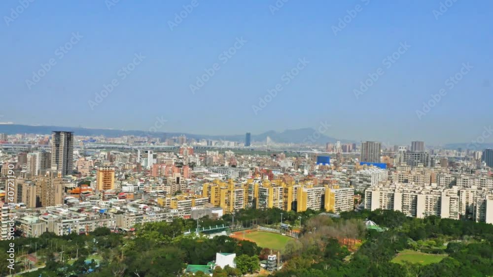 Aerial view of Taipei city, located in the north of the island of Taiwan. On the horizon you can appreciate the mountains. There is vegetation and parks around the buildings. 4K Aerial view of Taipei city, located in the north of the island of Taiwan. On the horizon you can appreciate the mountains. There is vegetation and parks around the buildings. 4K