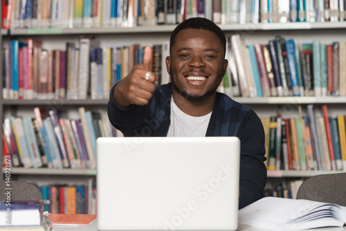 African Man In A Library Showing Thumbs Up