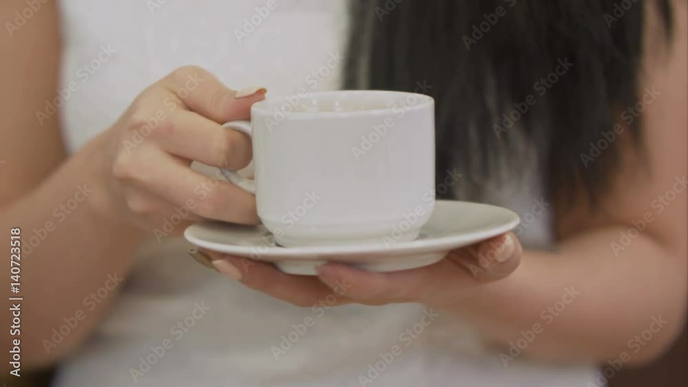 Female hand holding cup of black coffee Female hand holding cup of black coffee