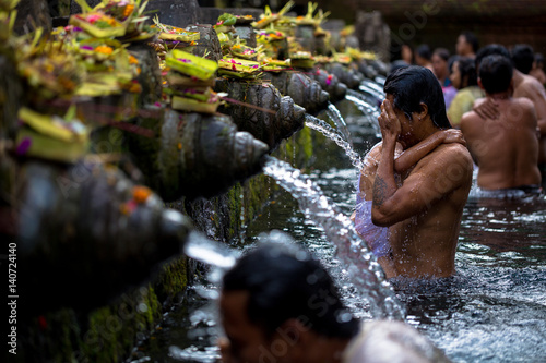 Man washes his face at Tirtha Empul water temple photo