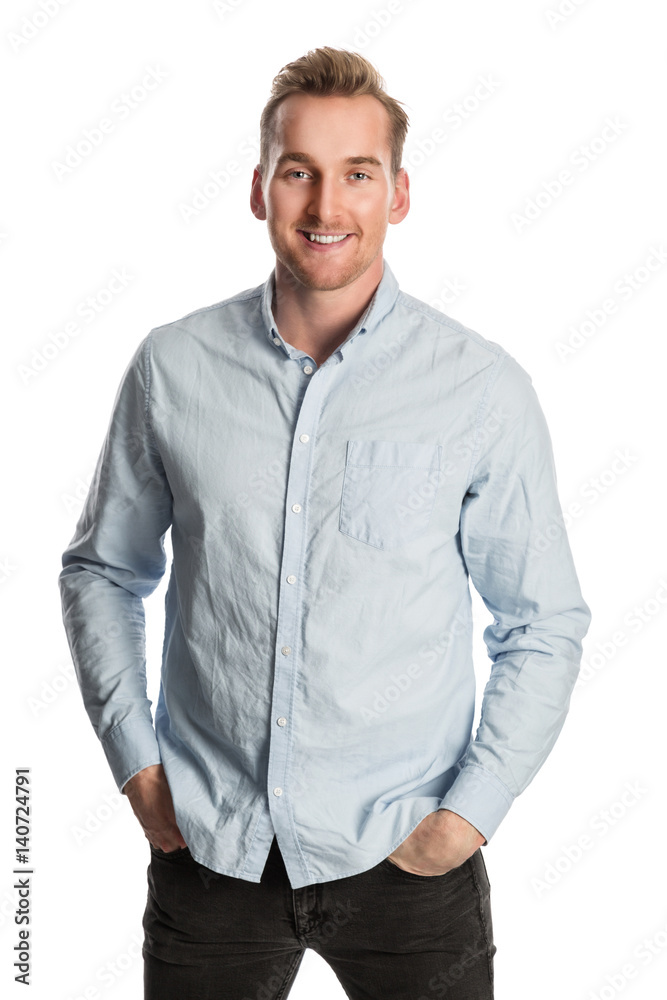 An attractive man wearing a light blue shirt and dark jeans with a big toothy smile. Standing against a white background. An attractive man wearing a light blue shirt and dark jeans with a big toothy smile. Standing against a white background.