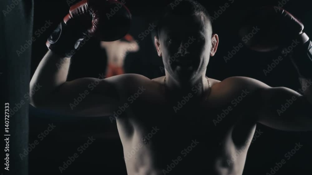Portrait of boxer champion in boxing gloves at Boxing Club
