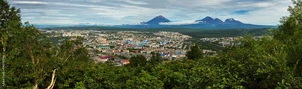Summer panorama of Petropavlovsk-Kamchatsky on background Avachinskaya group Volcano. View from Mishennaya hills.