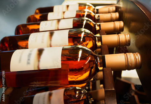 Bottles of wine or champagne on a wooden shelf