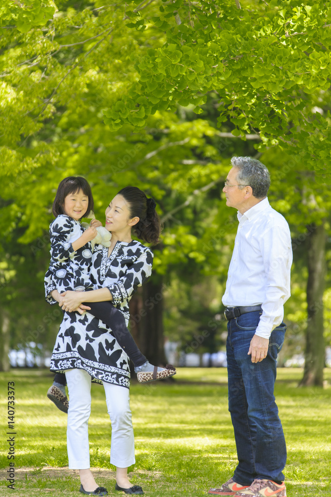 Girl visits park with her mother and grandfather Girl visits park with her mother and grandfather