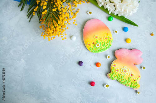 Decorated Easter Bunny and Egg Cookies Colorful Candies Comomiles Hyacinth on a white background. Easter concept.