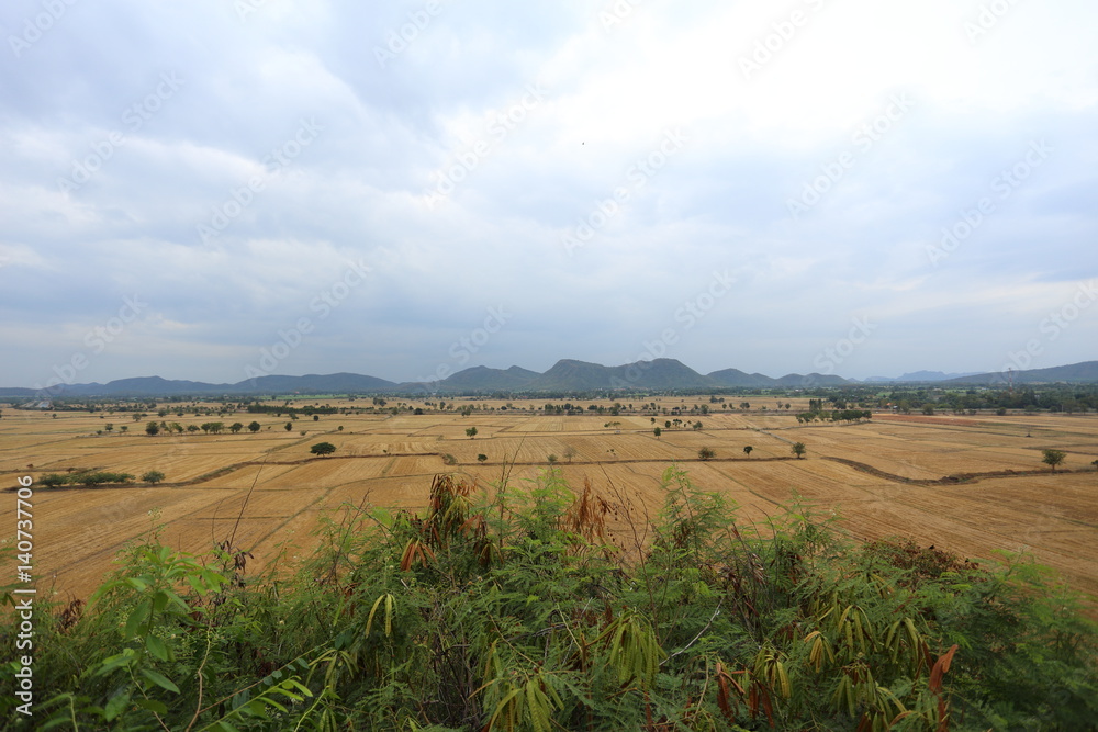 Fototapeta premium Field with mountain, Wat Tham Sua(Tiger Cave Temple) Kanchanburi, Thailand
