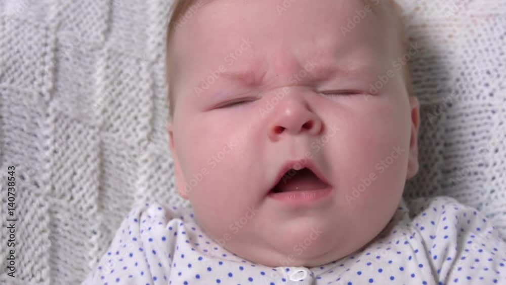 Cute baby sneezes loudly and smiles at the camera Cute baby sneezes loudly and smiles at the camera