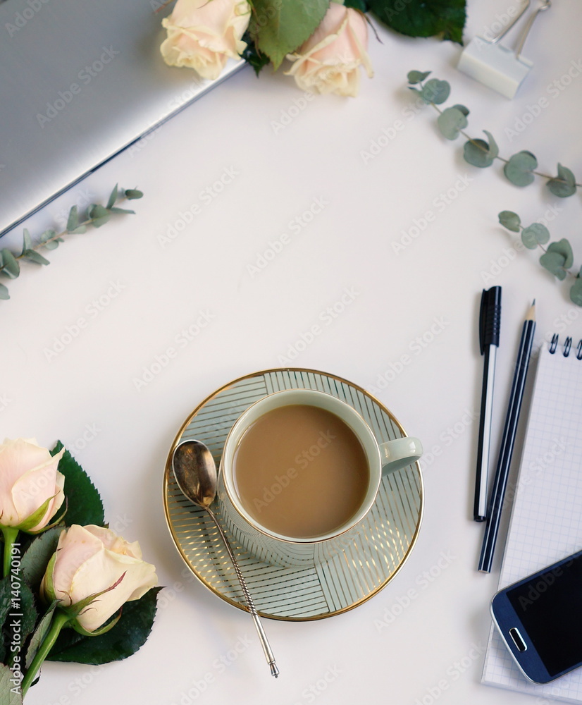 Flat lay, top view office table feminine desk. workspace with laptop, cup of cofee and bouquet pink roses.Mother's day, birthday Flat lay, top view office table feminine desk. workspace with laptop, cup of cofee and bouquet pink roses.Mother's day, birthday