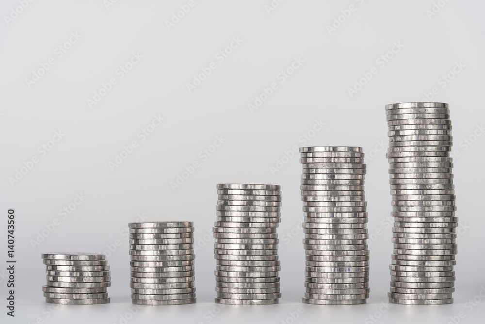 Increasing columns of coins, piles of coins arranged as a graph on white background