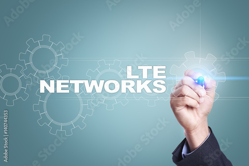 Businessman drawing on virtual screen. lte networks concept.