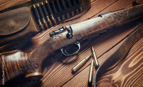 Hunting equipment on old wooden background. Toned