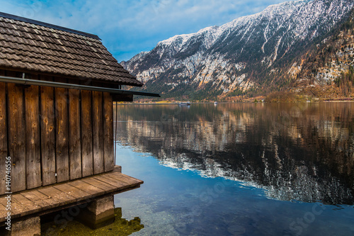 Wooden cabin in front of a like and a mountain in Hallstat, Austria photo