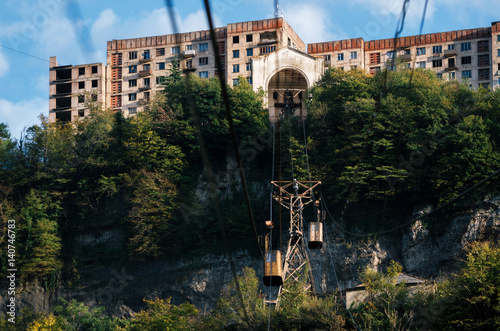 Derelict and rundown aerial old tram ropeway or cable car leading to the abandoned area in Chiatura. Industrial landmark of Georgia. photo