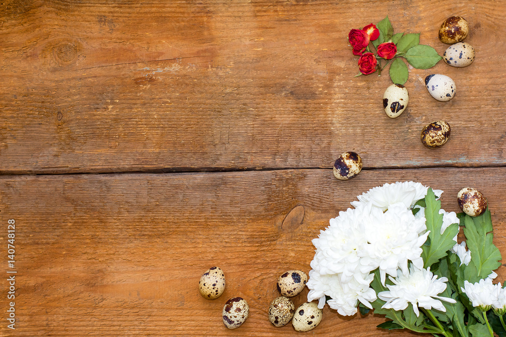 chrysanthemum flower, a small rose and a few quail eggs on wooden background. chrysanthemum flower, a small rose and a few quail eggs on wooden background.