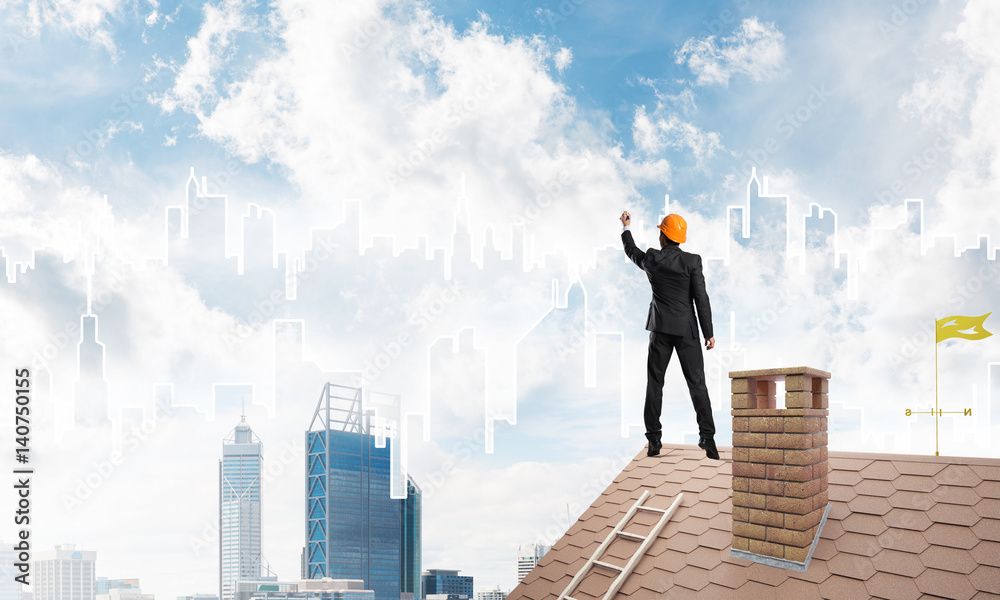 Man architect draw silhouette of modern city on blue sky. Mixed media Man architect draw silhouette of modern city on blue sky. Mixed media