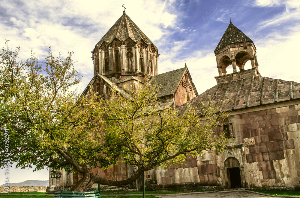 Fototapeta premium Monastery of St.John the Baptist in Gandzasar and yellowed old tree at the entrance 