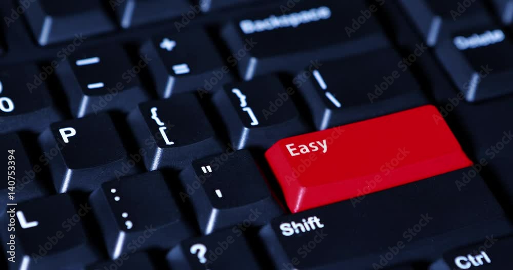 Video footage of human finger presses a red Easy button on the computer keyboard