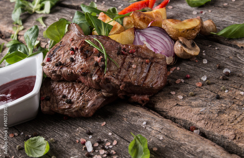 Beef steak on woode table, Fresh grilled steak with vegetable photo