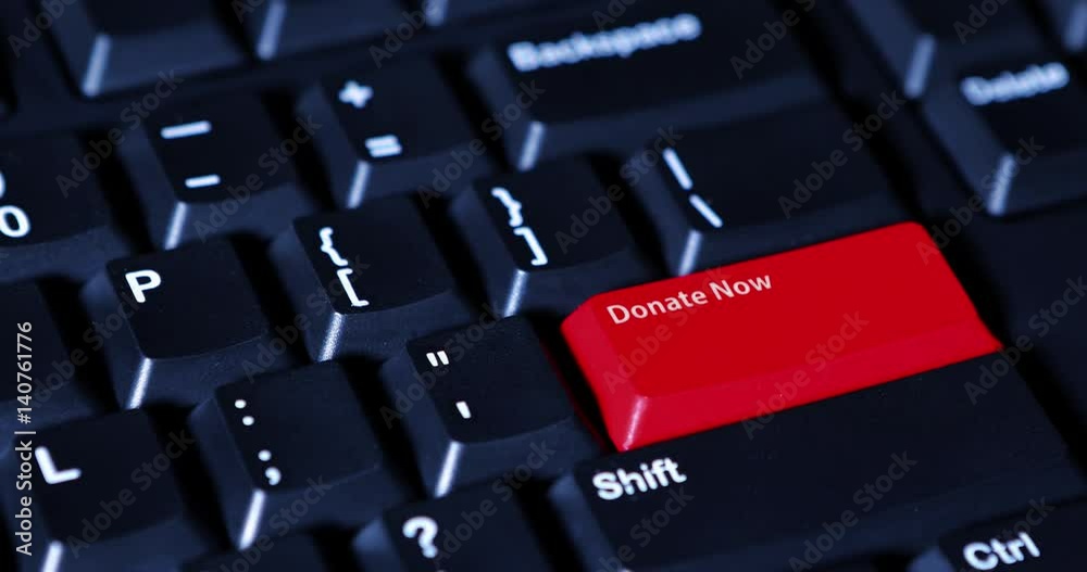 Human hand pressing a red button with text of Donate Now on the computer keyboard
Human hand pressing a red button with text of Donate Now on the computer keyboard