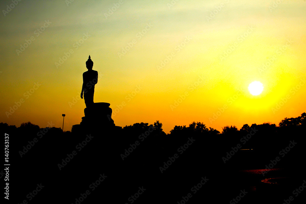 Sunset in Buddhist park in the Phutthamonthon district, Buddhamonthon. Nakhon Pathom Province of Thailand. (Silhouette of Buddha)