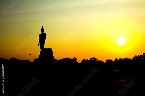 Sunset in Buddhist park in the Phutthamonthon district, Buddhamonthon. Nakhon Pathom Province of Thailand. (Silhouette of Buddha)