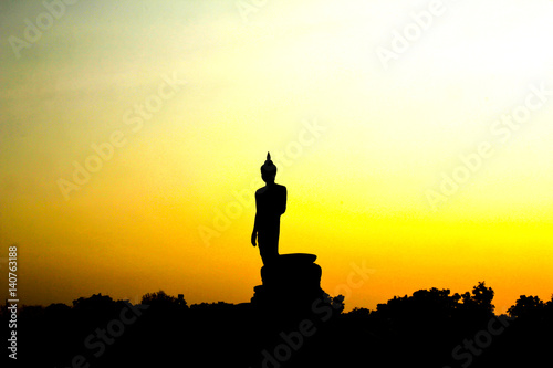 Sunset in Buddhist park in the Phutthamonthon district  Buddhamonthon. Nakhon Pathom Province of Thailand.  Silhouette of Buddha 