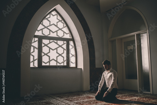 Muslim praying in a building with perfect background