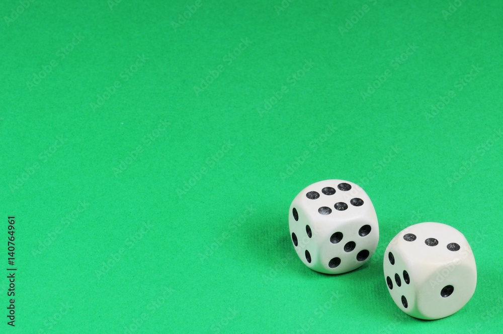 Old bone dice on green background with copy space. Old bone dice on green background with copy space.
