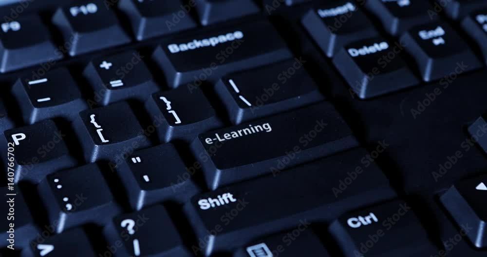 Close up of male hand pressing an E-Learning button on the computer keyboard Close up of male hand pressing an E-Learning button on the computer keyboard