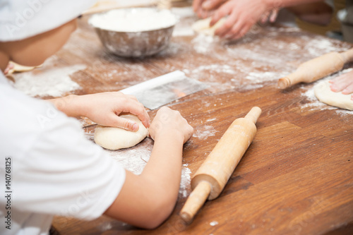 Young children make dough. Hands close up