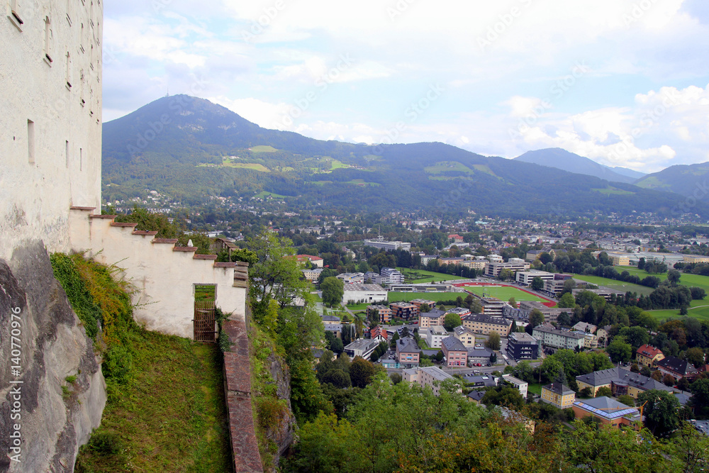 Naklejka premium Travel to Salzburg, Austria. The view on the city and the roofs of houses near to mountains.