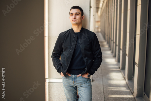 Fashionable man standing outdoors with white background © Serhiy Hipskyy