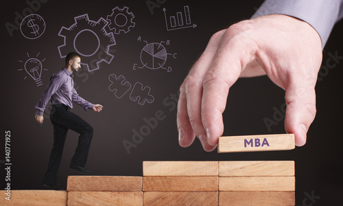 Business, Technology, Internet and network concept. Young businessman shows the word: MBA photo