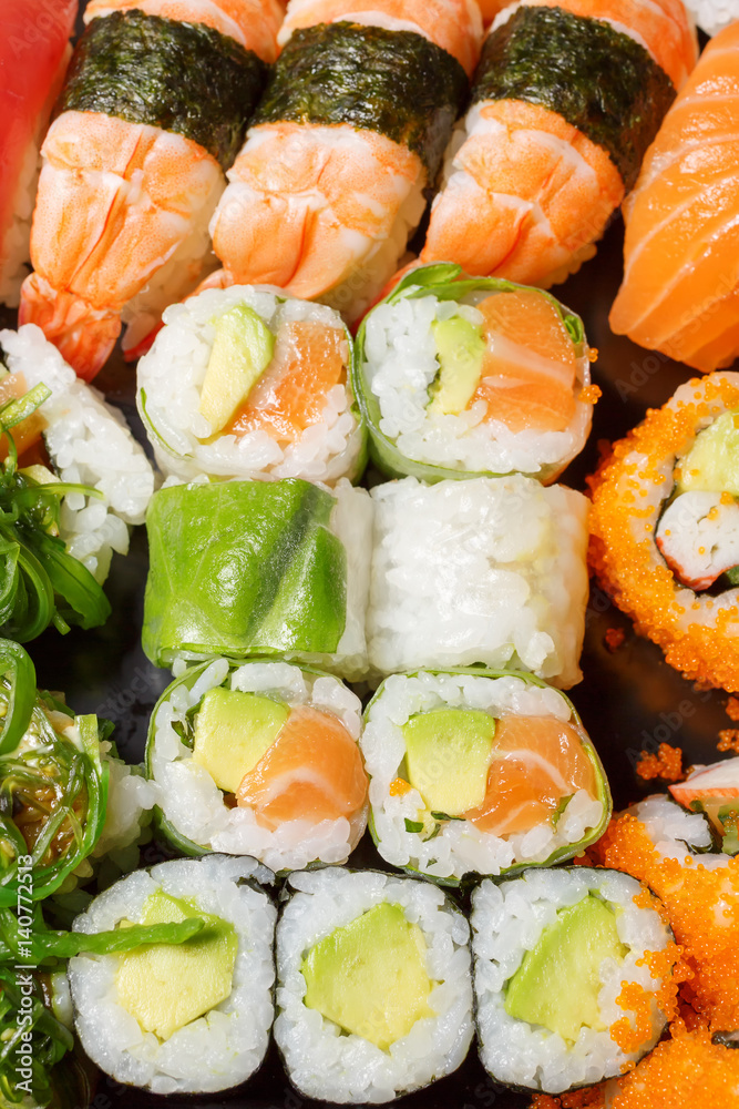 A large set of sushi and rolls top view close. Dishes from raw fish Japanese food A large set of sushi and rolls top view close. Dishes from raw fish Japanese food