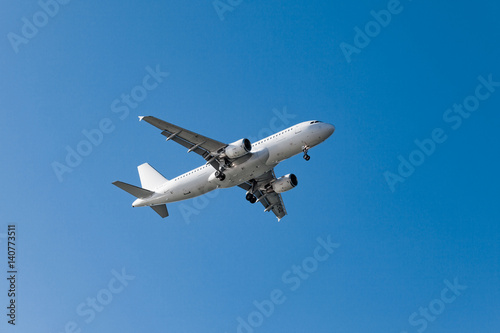 white airplane on a blue background. airplane in the sky